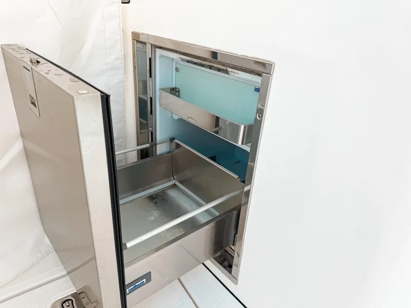 Slide: The Image of Open stainless steel drawer on 2022 Pursuit DC 365 Dual Console boat. - 20