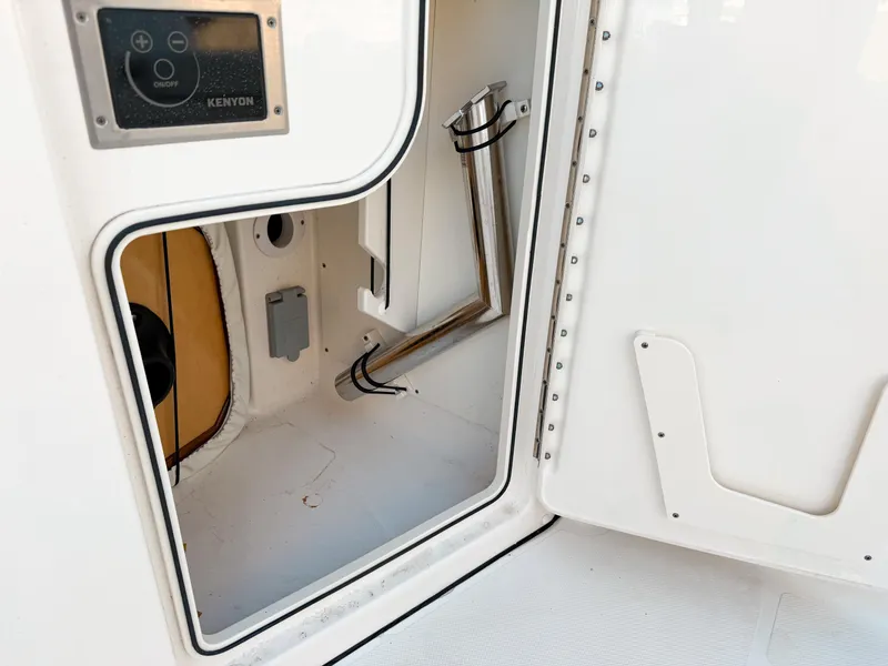 Slide: The Image of 2022 Pursuit DC 365 Dual Console storage compartment with control panel and interior details. - 21