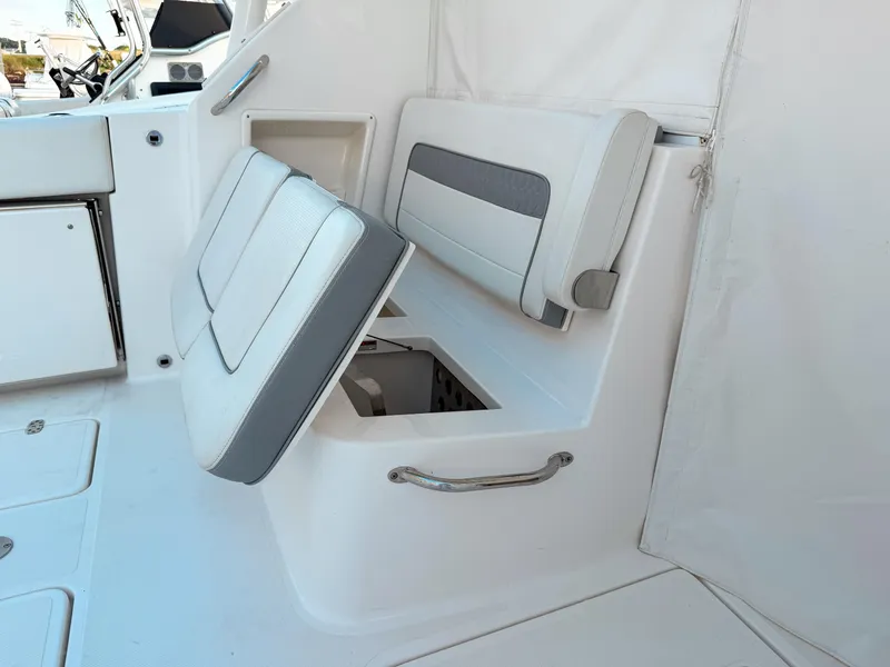 Slide: The Image of 2022 Pursuit DC 365 Dual Console boat interior with storage compartment and seating. - 23