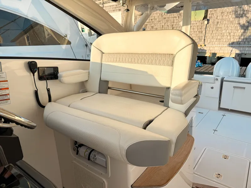 Slide: The Image of 2022 Pursuit DC 365 Dual Console boat interior with luxurious seating and control panel. - 26