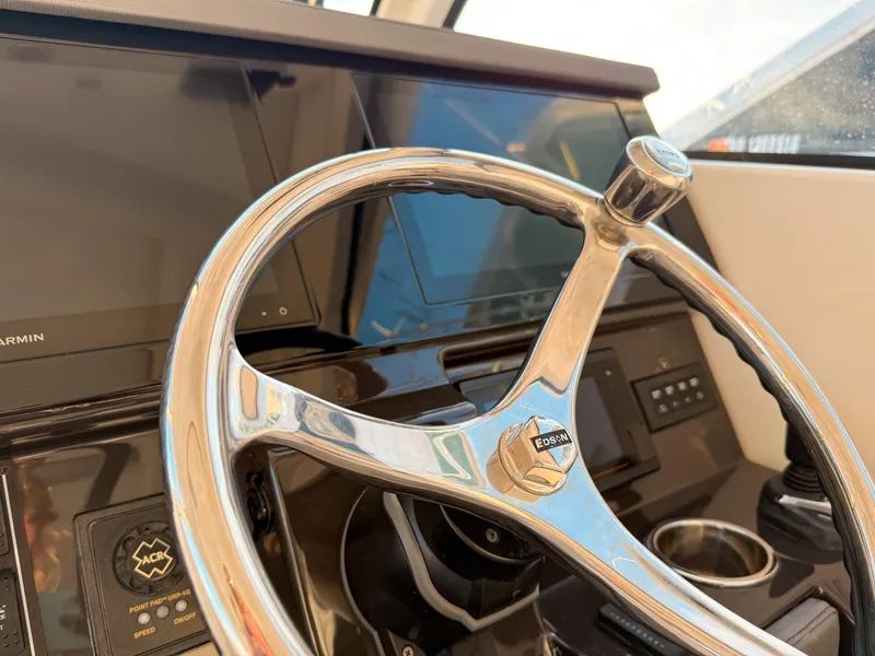 Slide: The Image of Steering wheel of 2022 Pursuit DC 365 Dual Console boat with modern dashboard. - 29