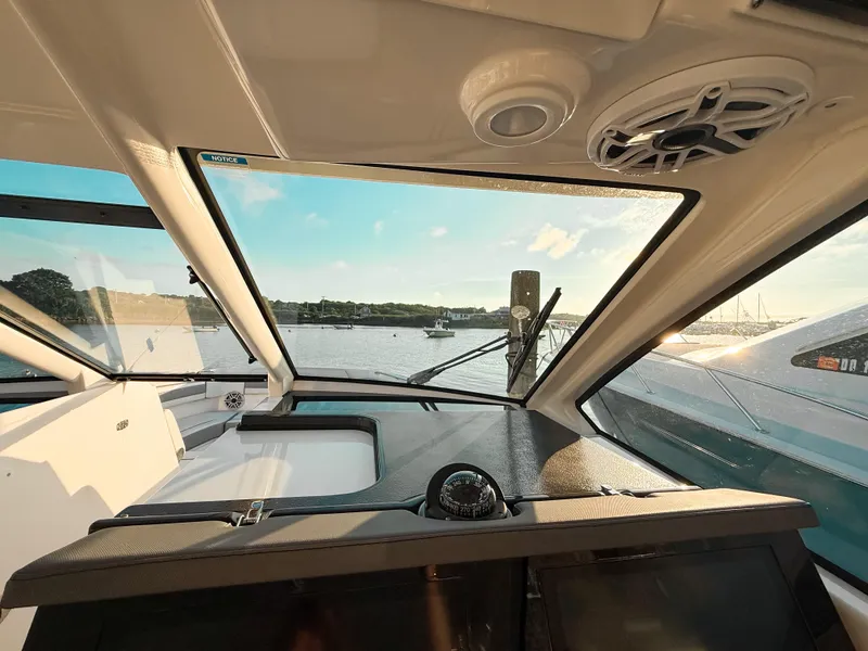 Slide: The Image of Interior view of 2022 Pursuit DC 365 Dual Console boat with scenic waterfront. - 30