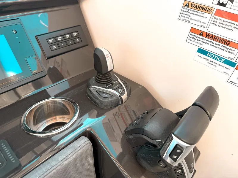 Slide: The Image of Control panel of 2022 Pursuit DC 365 Dual Console boat with joystick and throttle. - 32