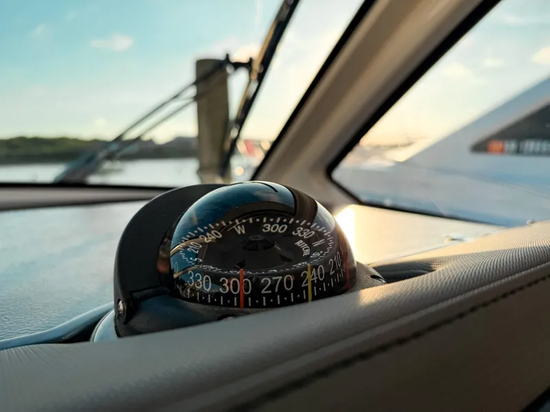 Slide: The Image of Compass on 2022 Pursuit DC 365 Dual Console boat, with scenic water view. - 34