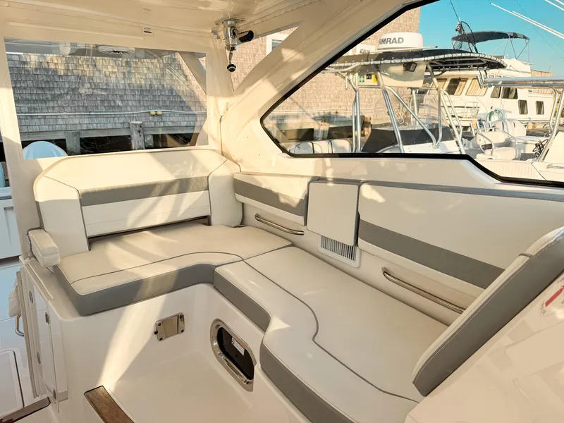 Slide: The Image of 2022 Pursuit DC 365 Dual Console boat interior with cushioned seating and modern design. - 36