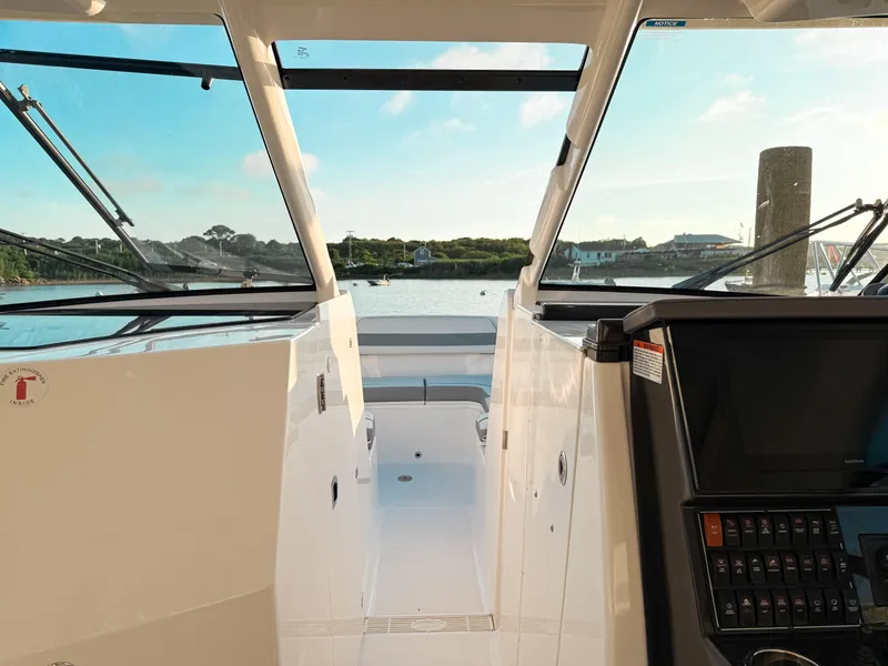 Slide: The Image of 2022 Pursuit DC 365 Dual Console boat interior with scenic water view. - 38