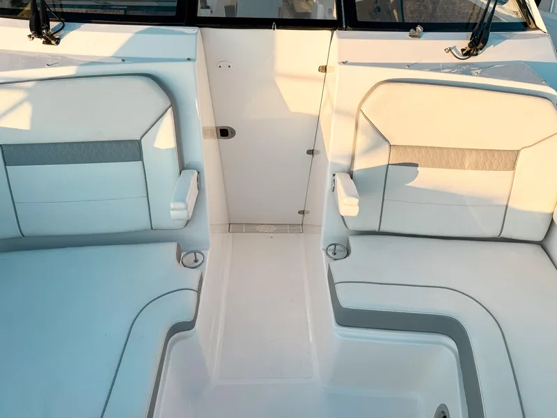Slide: The Image of 2022 Pursuit DC 365 Dual Console boat interior with white cushioned seating. - 43