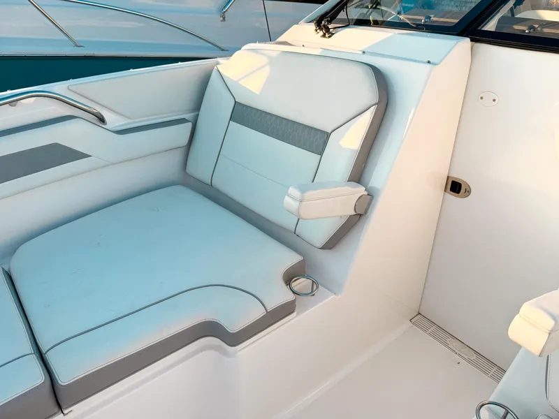 Slide: The Image of 2022 Pursuit DC 365 Dual Console boat interior with cushioned seating and armrest. - 44