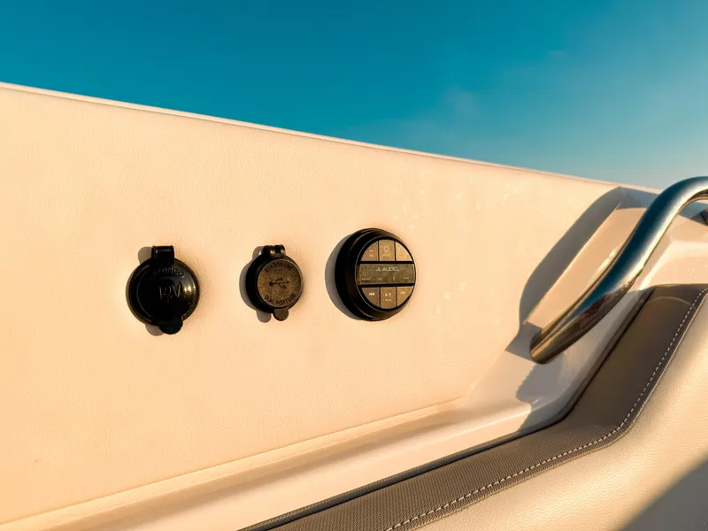 Slide: The Image of Control panel on 2022 Pursuit DC 365 Dual Console boat, featuring audio and power outlets. - 46