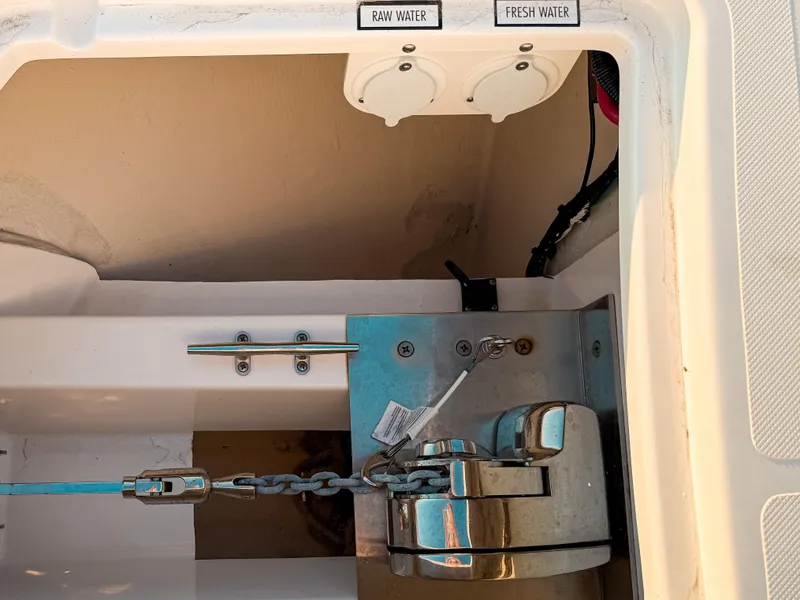 Slide: The Image of Anchor compartment of 2022 Pursuit DC 365 Dual Console with raw and fresh water access. - 47