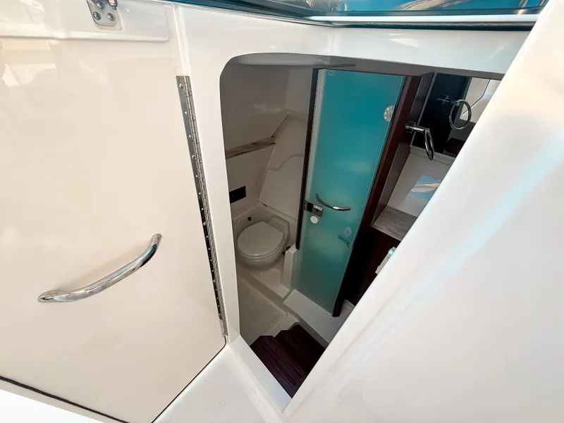 Slide: The Image of 2022 Pursuit DC 365 Dual Console boat interior bathroom with modern fixtures and sleek design. - 48