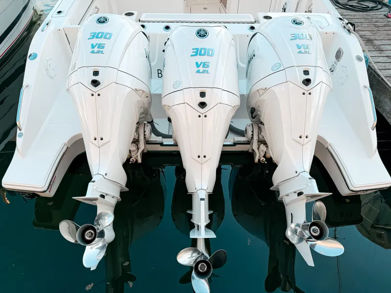 Slide: The Image of Triple Yamaha 300 V6 outboard engines on a 2022 Pursuit DC 365 Dual Console boat. - 5