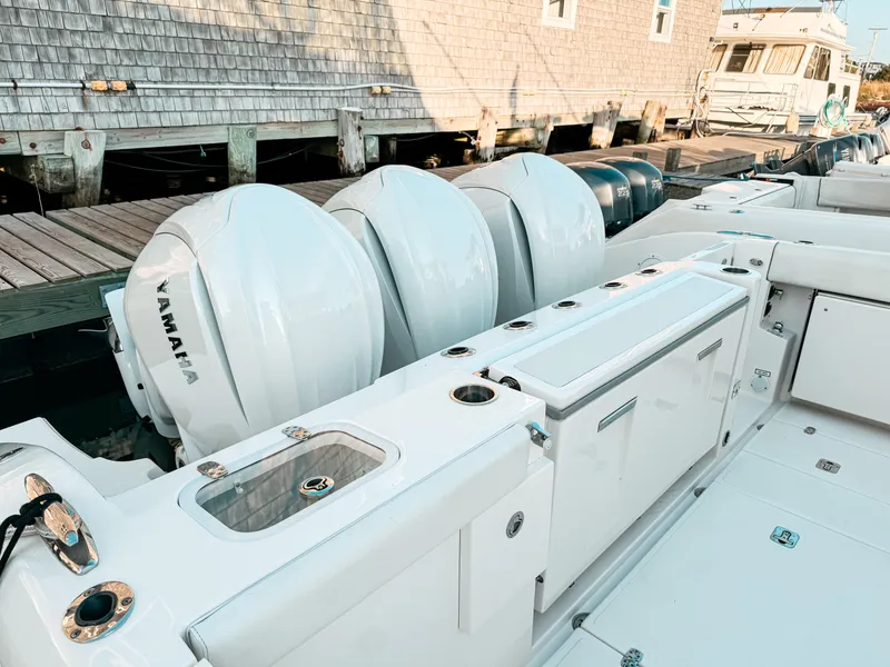 Slide: The Image of 2022 Pursuit DC 365 Dual Console boat with Yamaha engines docked at a marina. - 6