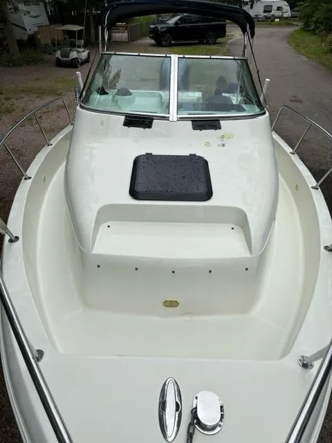 Slide: The Image of 2006 Caravelle Sea Hawk 230 Walk Around boat, white deck, windshield, and railing. - 7