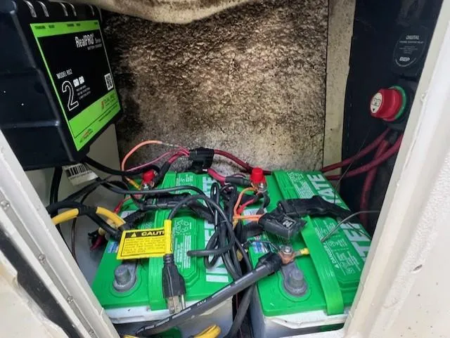 Slide: The Image of Battery compartment of 2006 Caravelle Sea Hawk 230 Walk Around boat with wiring and charger. - 9