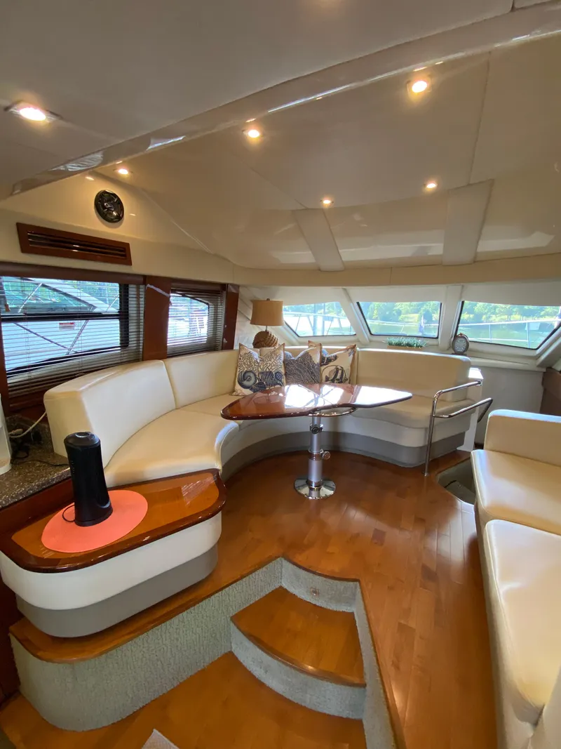 Slide: The Image of Luxurious interior of 2008 Sea Ray 47 Sedan Bridge yacht with elegant seating and wooden flooring. - 10