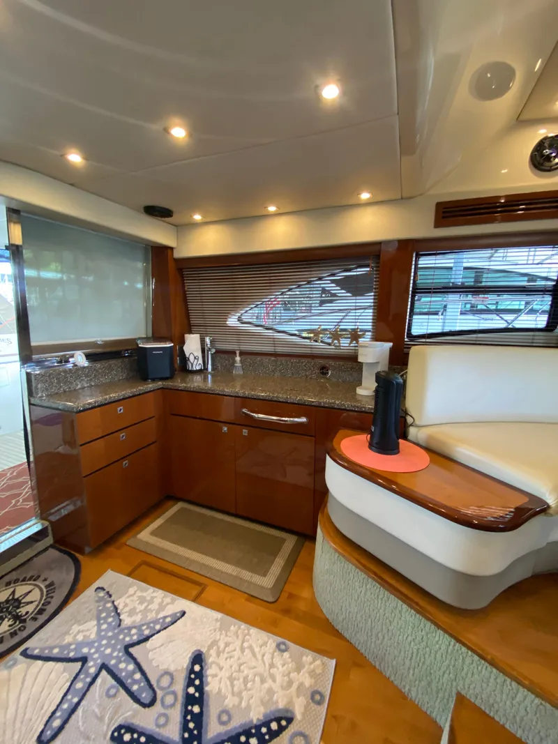 Slide: The Image of Luxurious interior of 2008 Sea Ray 47 Sedan Bridge yacht with modern kitchen amenities. - 14