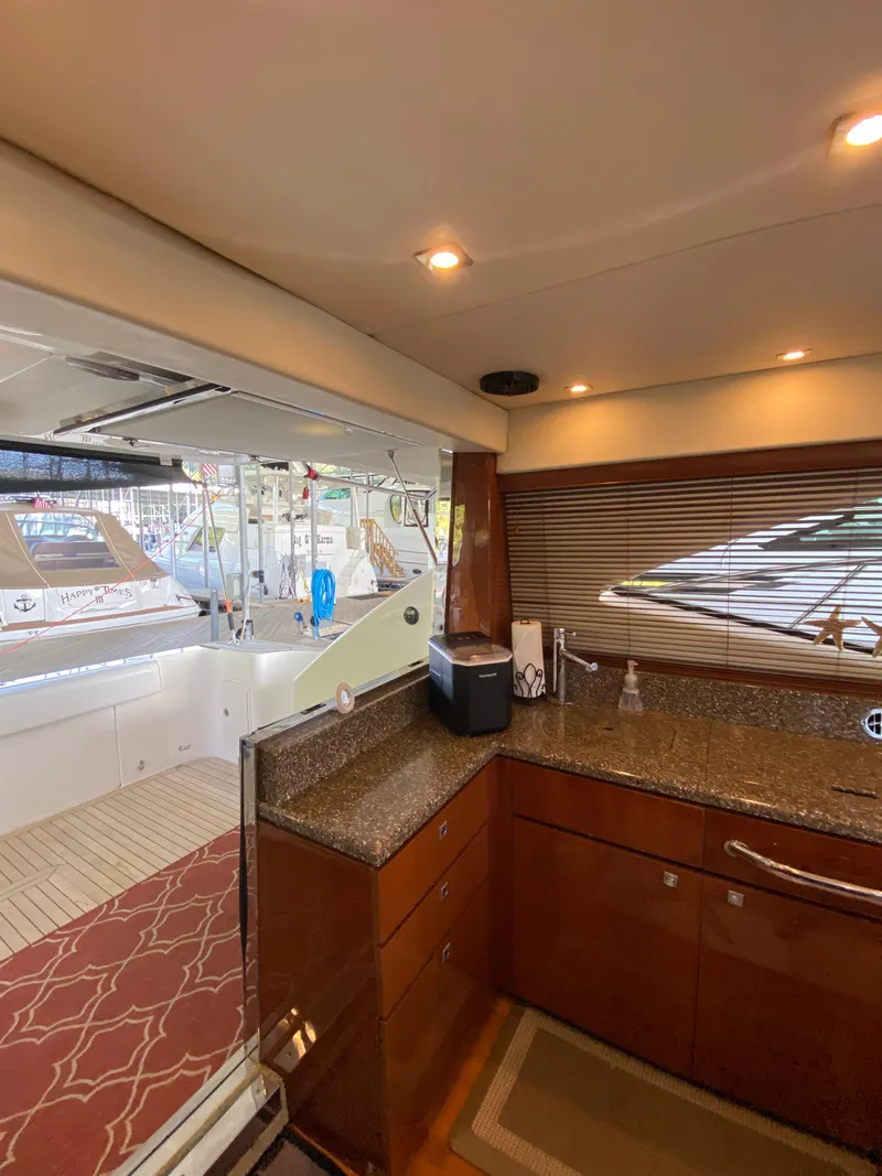 Slide: The Image of Interior view of 2008 Sea Ray 47 Sedan Bridge yacht kitchen area with granite countertops. - 16