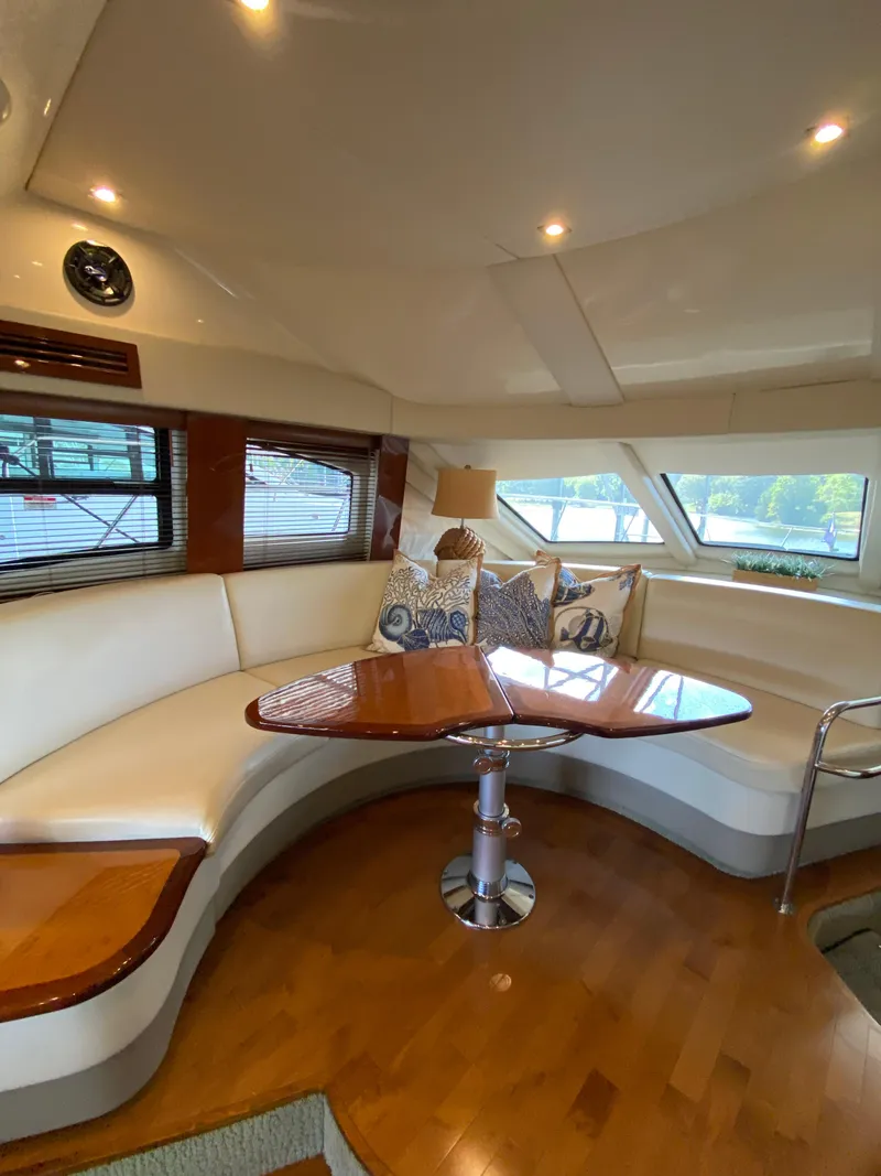 Slide: The Image of 2008 Sea Ray 47 Sedan Bridge interior with elegant seating and wooden table. - 17