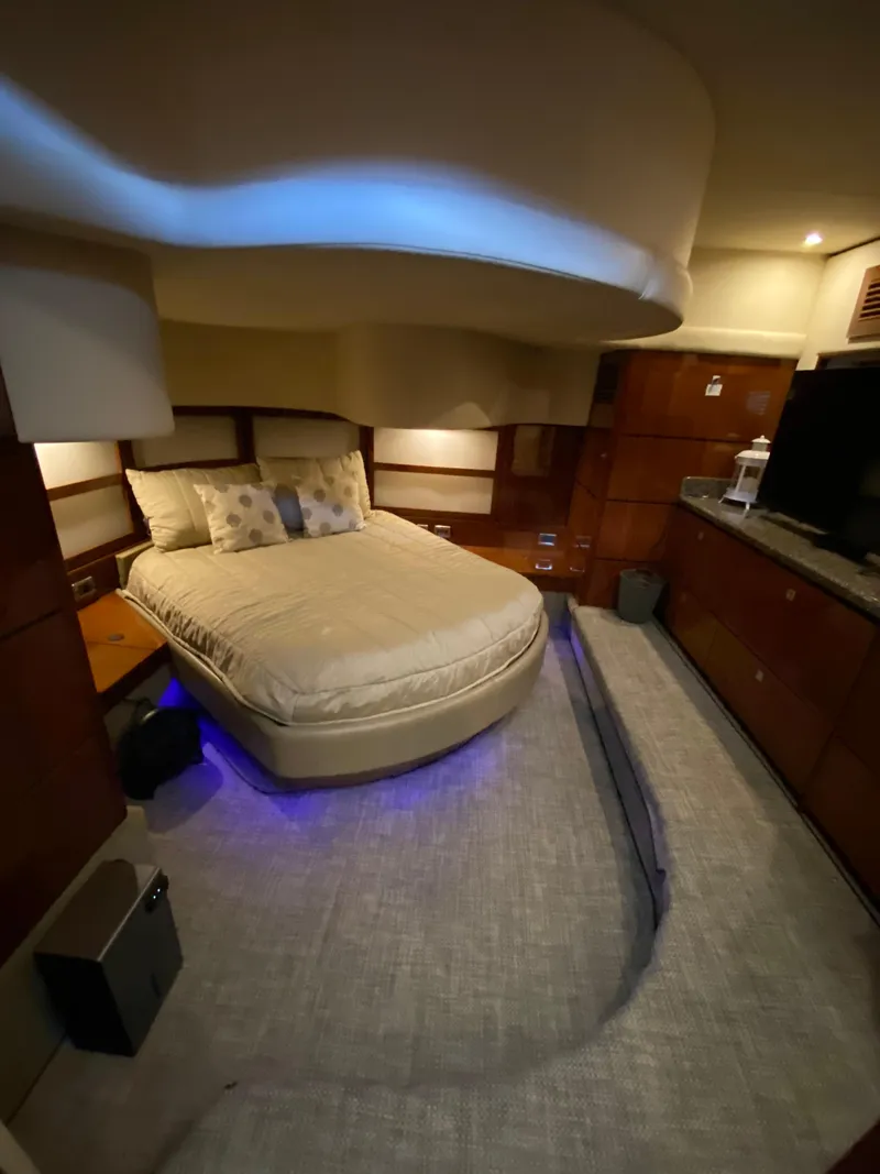 Slide: The Image of Luxurious 2008 Sea Ray 47 Sedan Bridge yacht bedroom with ambient lighting and elegant decor. - 20