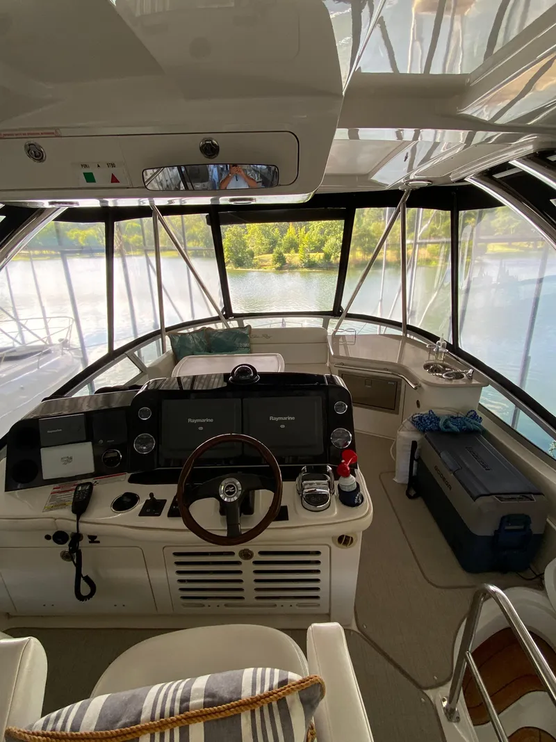 Slide: The Image of 2008 Sea Ray 47 Sedan Bridge helm with modern controls and panoramic views. - 28