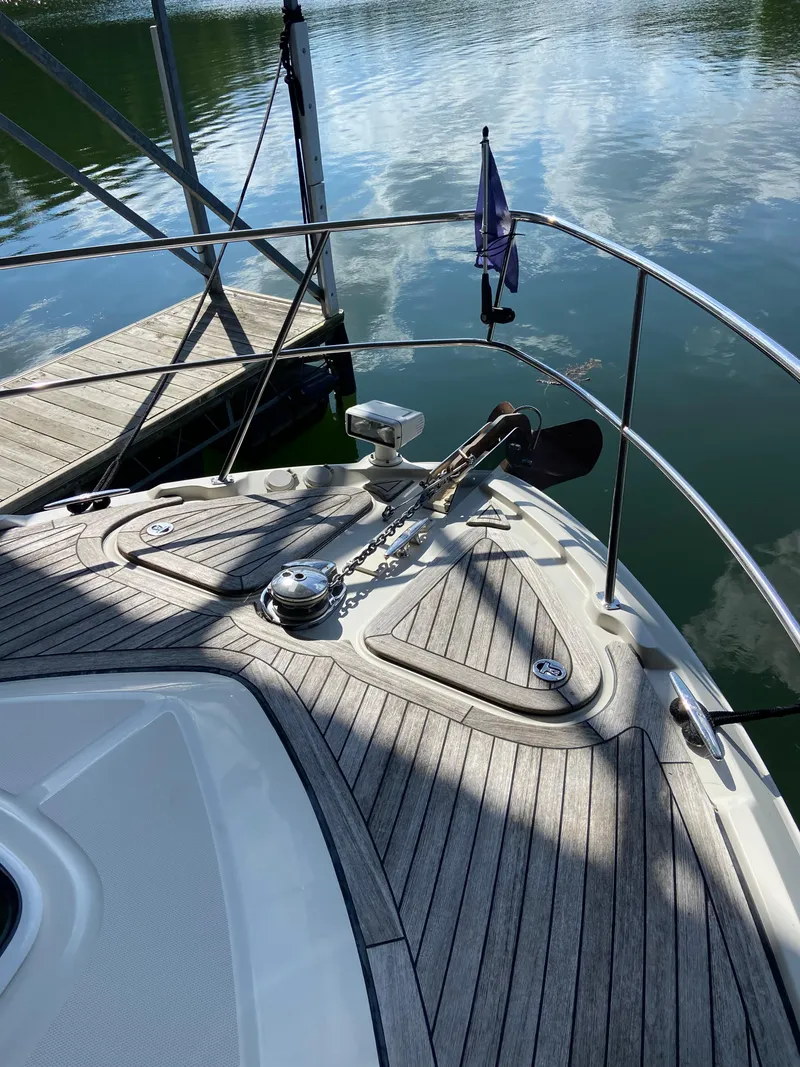 Slide: The Image of 2008 Sea Ray 47 Sedan Bridge bow with anchor, docked on calm water. - 35