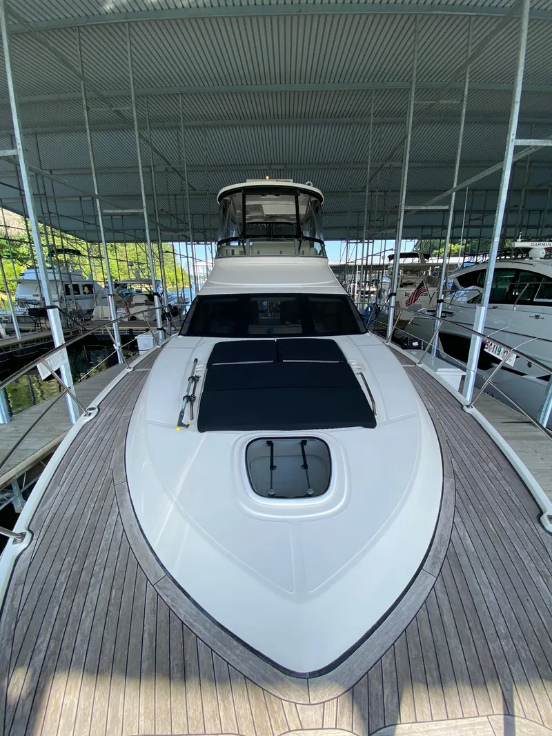Slide: The Image of 2008 Sea Ray 47 Sedan Bridge yacht docked under a covered marina. - 36
