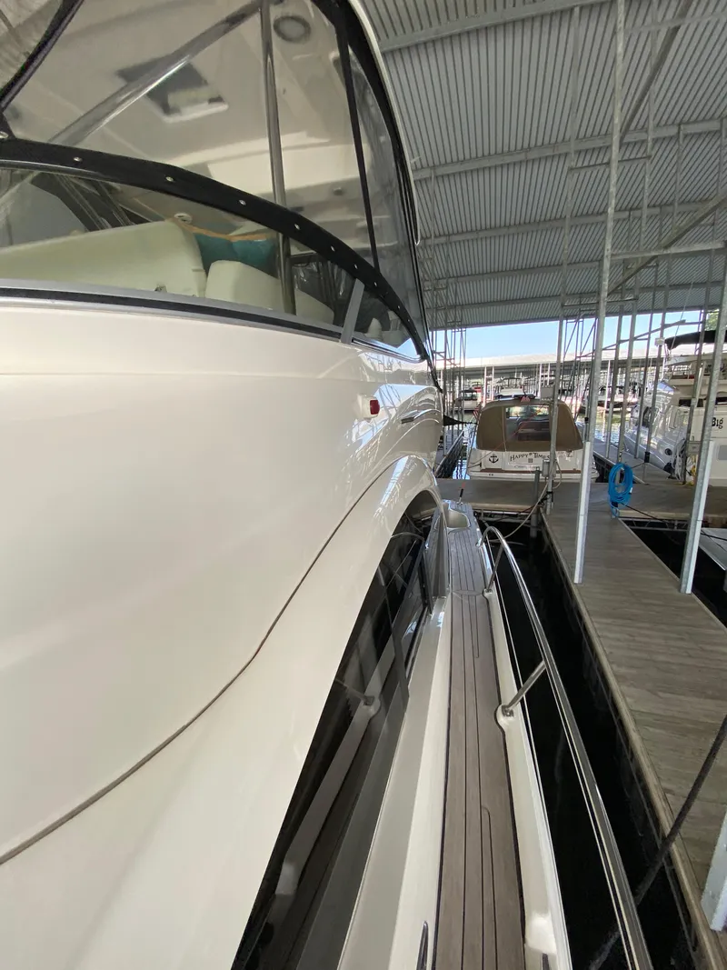 Slide: The Image of 2008 Sea Ray 47 Sedan Bridge yacht docked in a marina, side view. - 38
