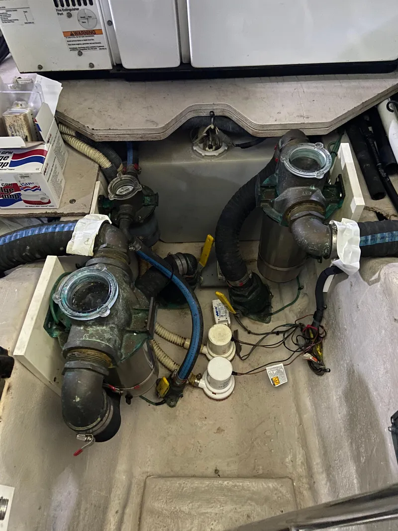 Slide: The Image of Engine compartment of a 2008 Sea Ray 47 Sedan Bridge with visible hoses and components. - 40