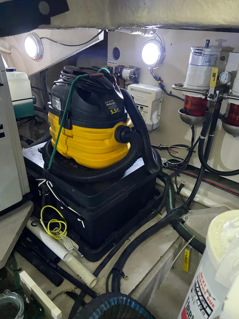 Slide: The Image of Engine room of 2008 Sea Ray 47 Sedan Bridge with equipment and maintenance tools. - 42