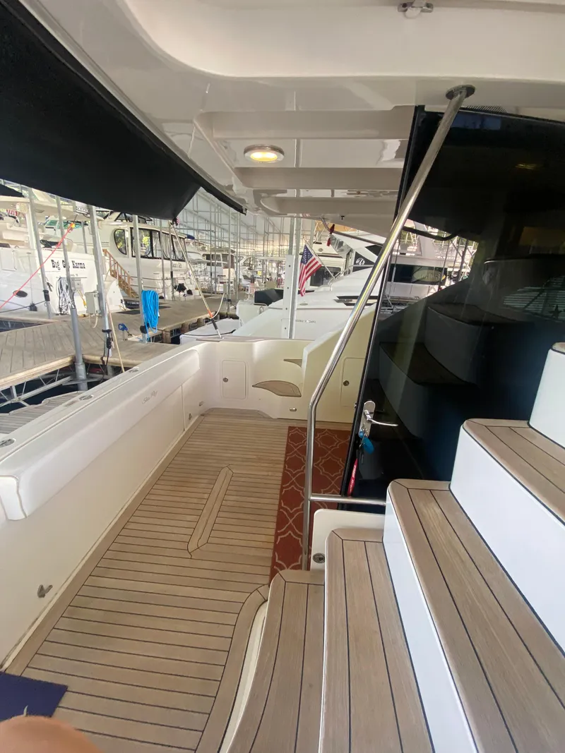 Slide: The Image of 2008 Sea Ray 47 Sedan Bridge yacht interior with wooden deck and stairs. - 7
