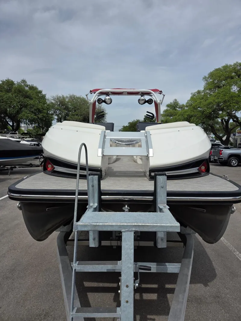 Slide: The Image of 2020 Bennington QX 25 Sport pontoon boat on trailer, parked outdoors. - 4