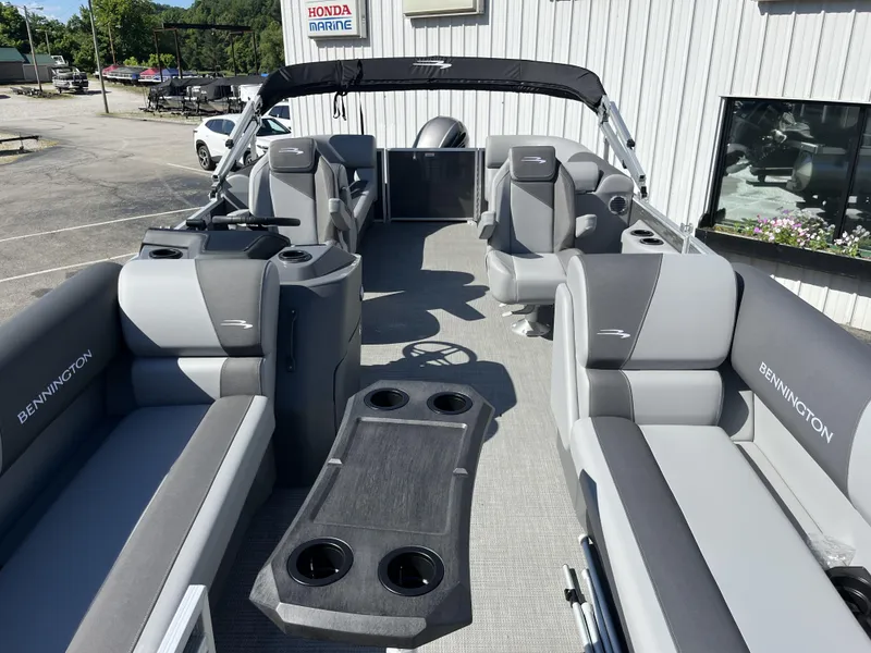 Slide: The Image of 2024 Bennington 22 SVSR pontoon boat interior with gray seating and cup holders. - 3