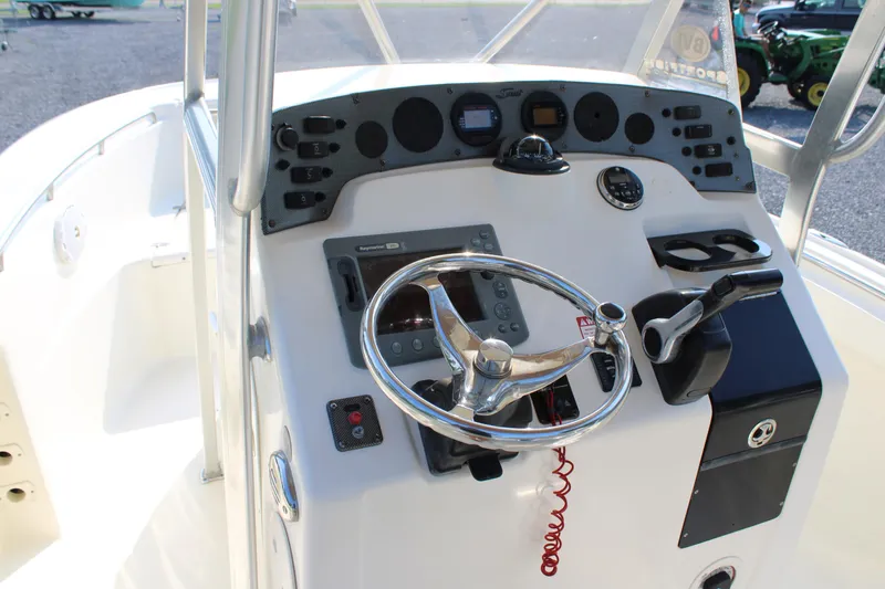 Slide: The Image of 2007 Scout 222 Sportfish boat dashboard with steering wheel and controls. - 11