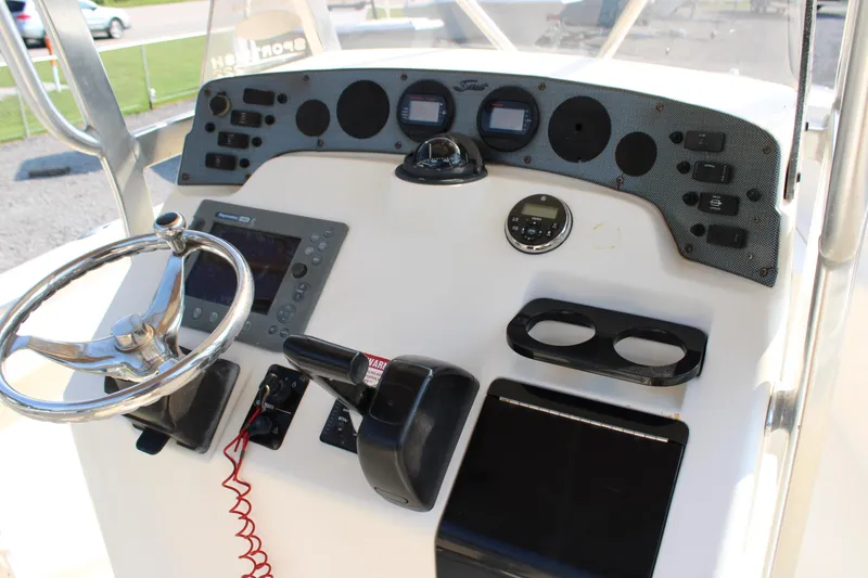 Slide: The Image of 2007 Scout 222 Sportfish boat dashboard with steering wheel and control panel. - 22
