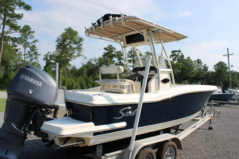 Slide: The Image of 2007 Scout 222 Sportfish boat on trailer with Yamaha outboard motor, parked outdoors. - 9