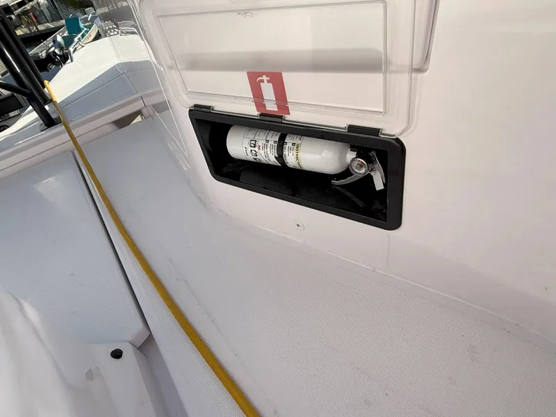 Slide: The Image of Fire extinguisher compartment on 2024 Axopar Cross Cabin boat. - 22