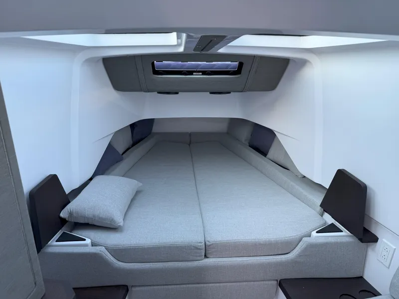 Slide: The Image of 2024 Axopar Cross Cabin boat deck with blue LED light and sleek design. - 44