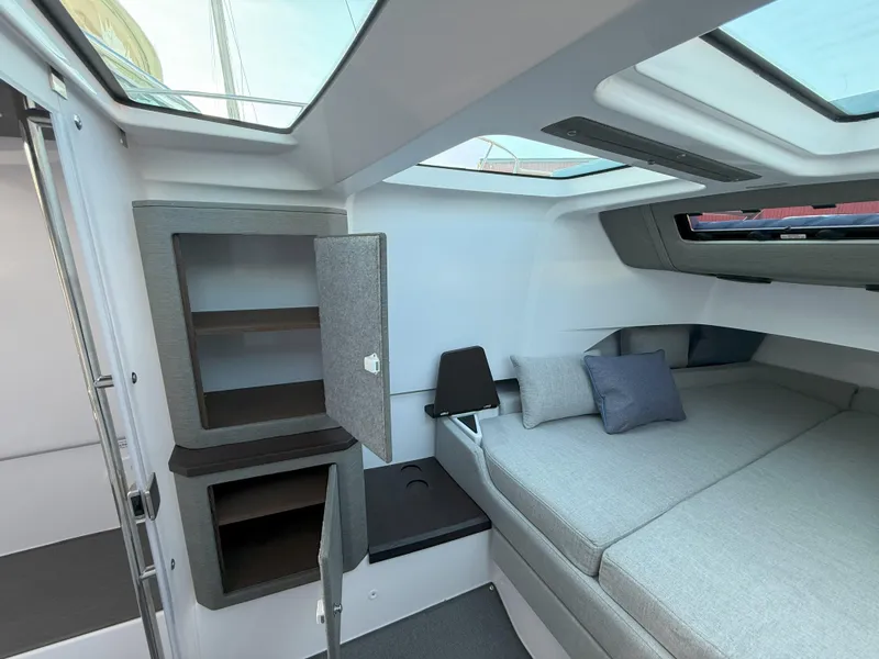 Slide: The Image of 2024 Axopar Cross Cabin interior with modern design, skylights, and comfortable seating. - 47