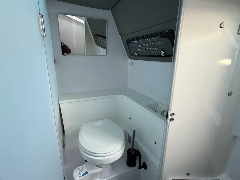 Slide: The Image of 2024 Axopar Cross Cabin interior with skylights, gray seating, and storage cabinets. - 51