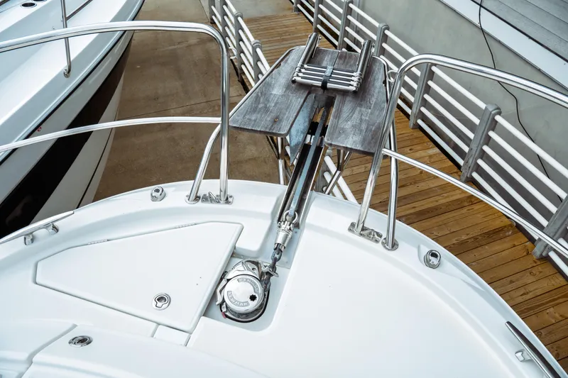 Slide: The Image of 2023 Jeanneau NC 1095 boat bow with anchor and deck railing. - 10