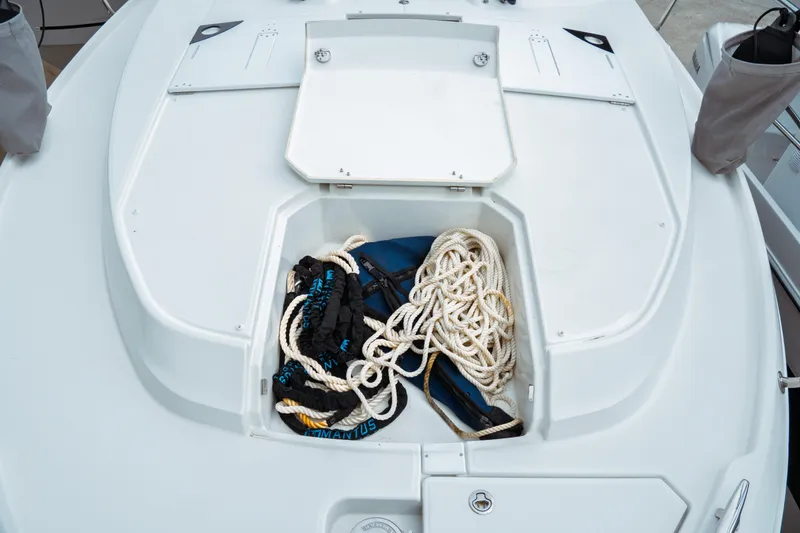 Slide: The Image of Open storage compartment on 2023 Jeanneau NC 1095 boat with ropes and equipment. - 16