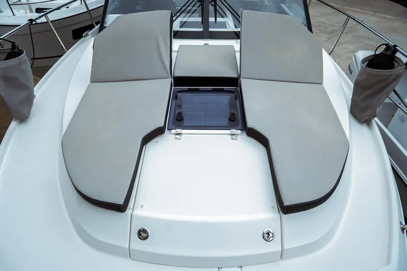 Slide: The Image of 2023 Jeanneau NC 1095 boat with cushioned sunbathing area on deck. - 17