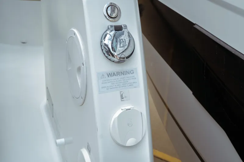 Slide: The Image of 2023 Jeanneau NC 1095 boat detail showing warning label and fittings. - 28