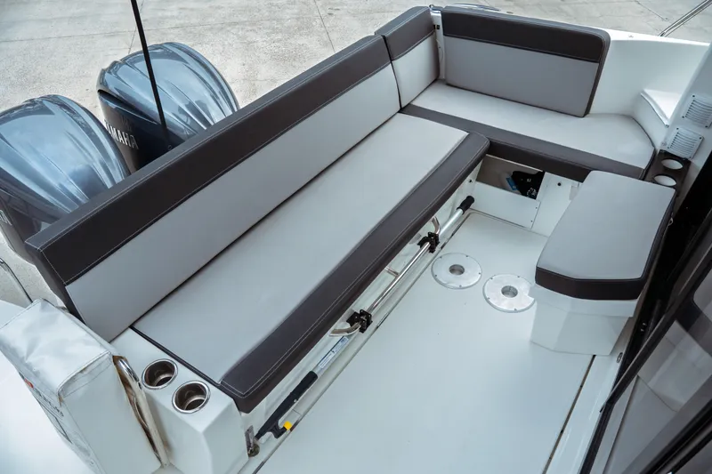 Slide: The Image of 2023 Jeanneau NC 1095 boat seating area with dual outboard motors. - 31