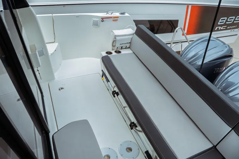 Slide: The Image of 2023 Jeanneau NC 1095 boat deck with seating and twin Yamaha engines. - 32