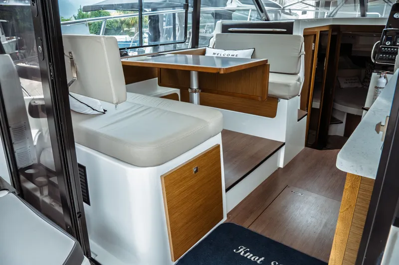 Slide: The Image of Interior of 2023 Jeanneau NC 1095 boat with modern seating and wooden accents. - 33