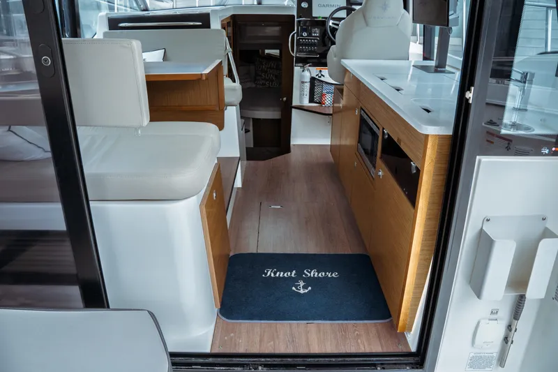 Slide: The Image of Interior of 2023 Jeanneau NC 1095 boat with modern seating and kitchen area. - 35
