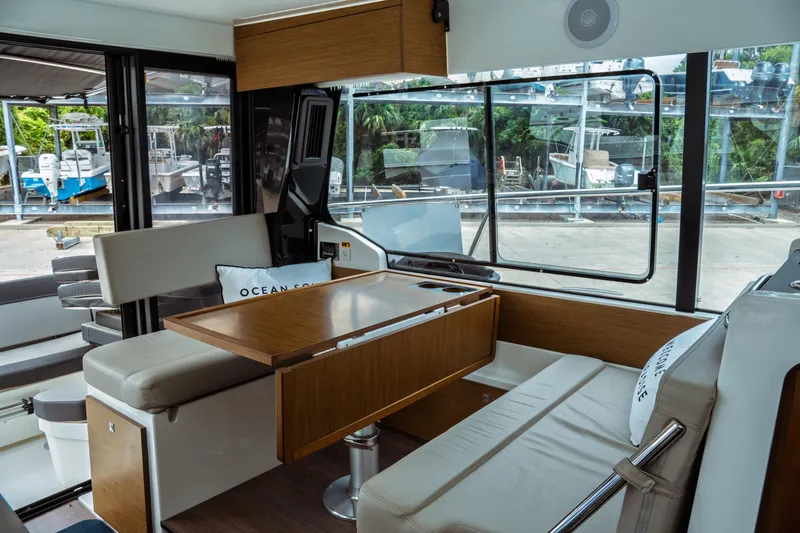 Slide: The Image of Interior of 2023 Jeanneau NC 1095 boat with modern seating and dining area. - 37