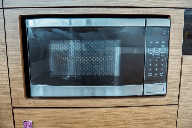 Slide: The Image of Built-in microwave on Jeanneau NC 1095, 2023 model, with wood paneling. - 49